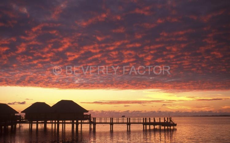 Island Sunsets;Moorea;sky;sillouettes;sunset;water;red;colorful;yellow;ocean;huts;pink;clouds